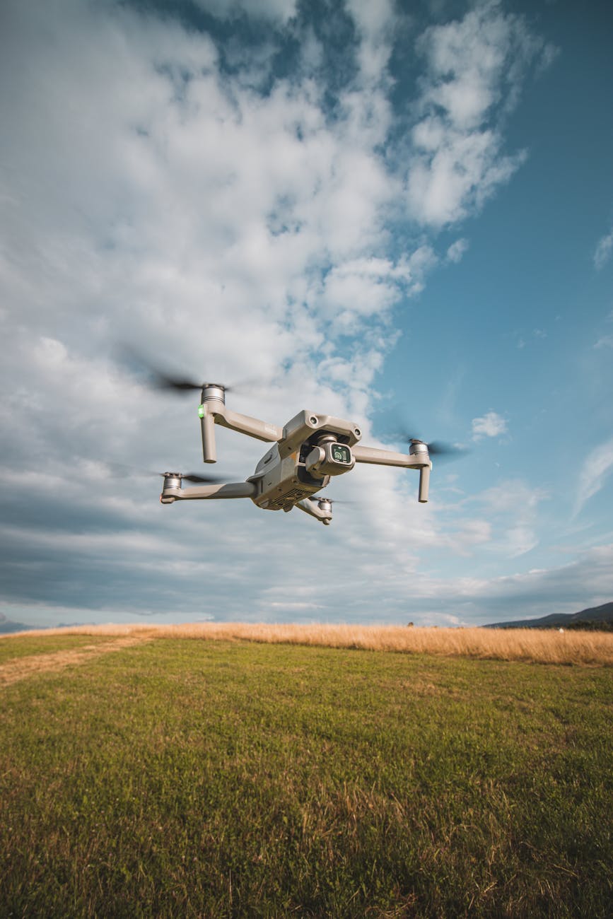 Drone captured flying over a scenic rural field in Liberec, Czechia on a clear day.