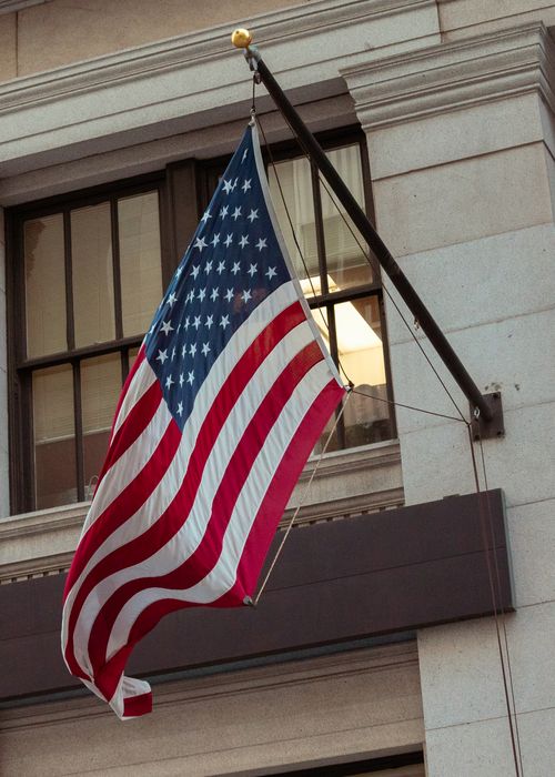 Free Vertical shot of an American flag on a building in San Francisco, California. Stock Photo