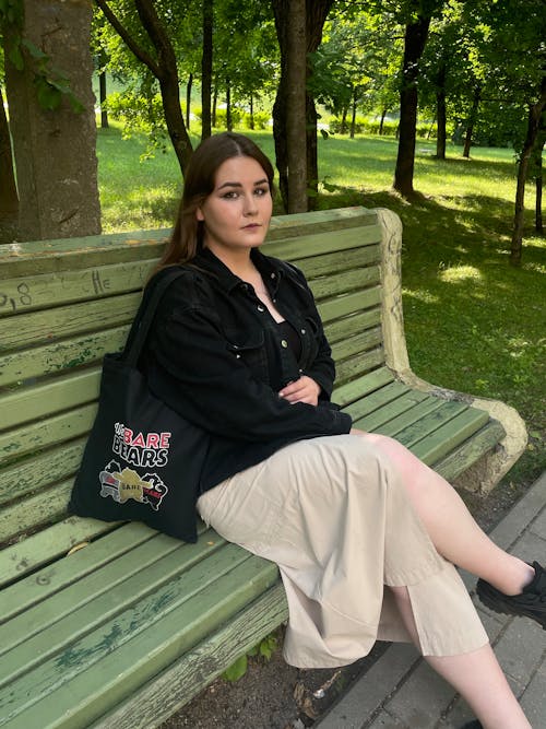 Woman Sitting on Bench in Park