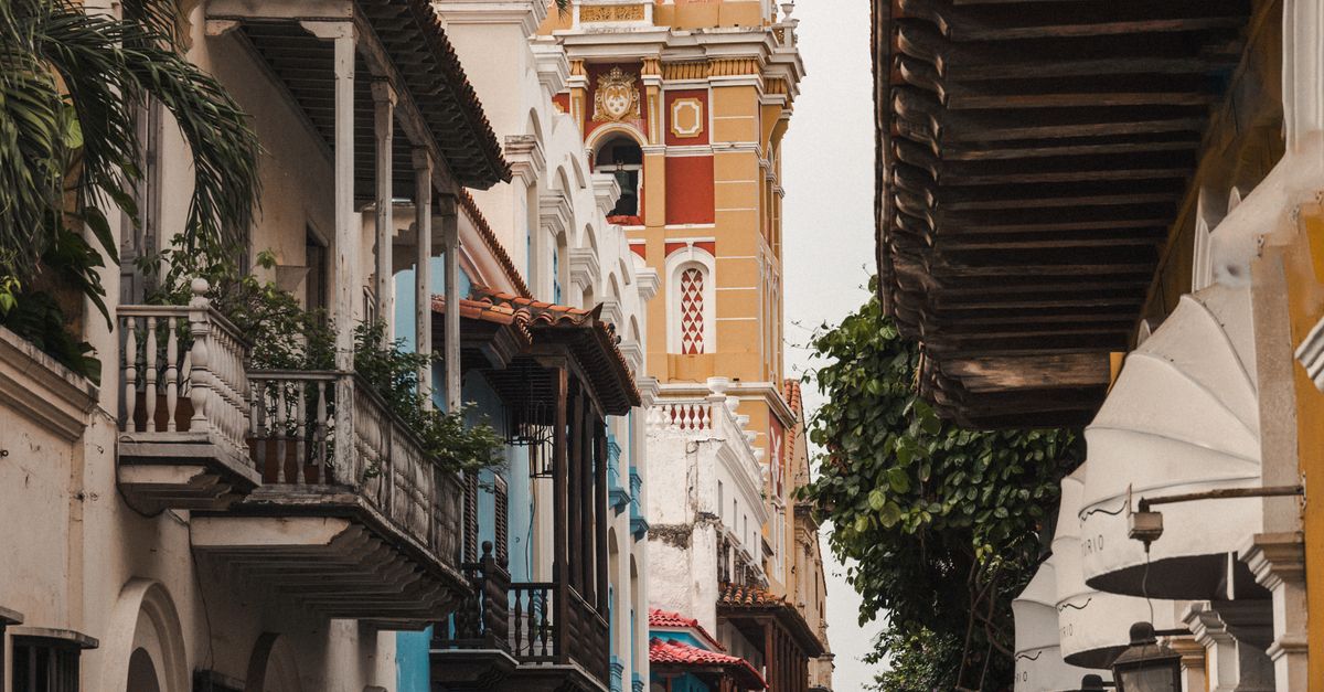 Scenic street scene in Cartagena featuring the iconic cathedral tower.