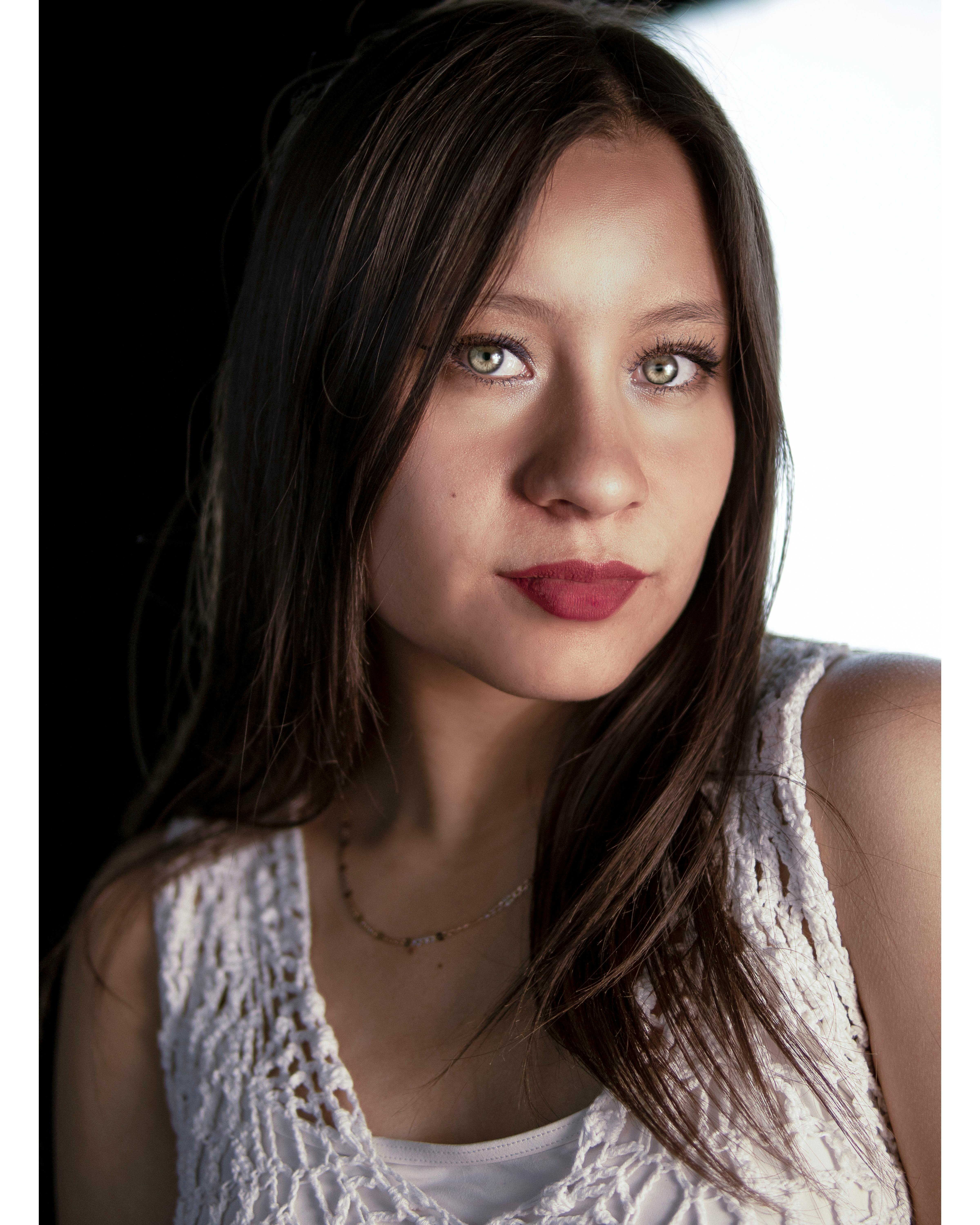 Close-up portrait of a woman with long brown hair and natural makeup.