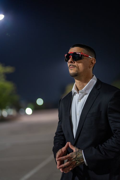 Man in Suit and Sunglasses at Night