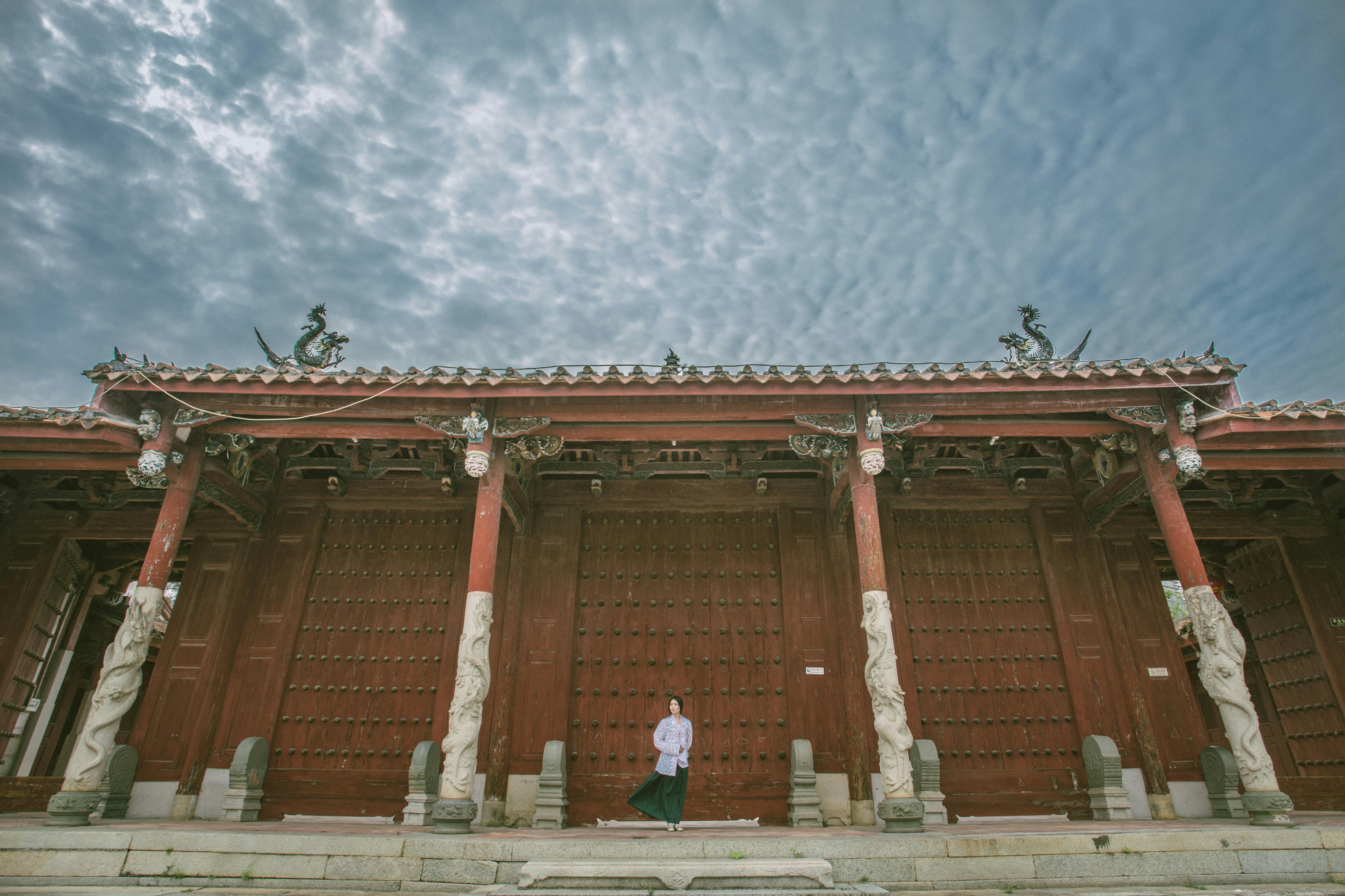 person standing near red gate