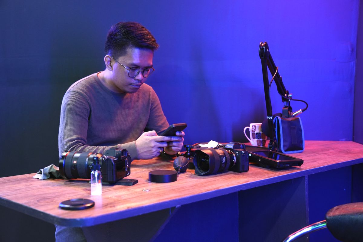 YouTube creator workspace with cameras microphone smartphone and content creation equipment