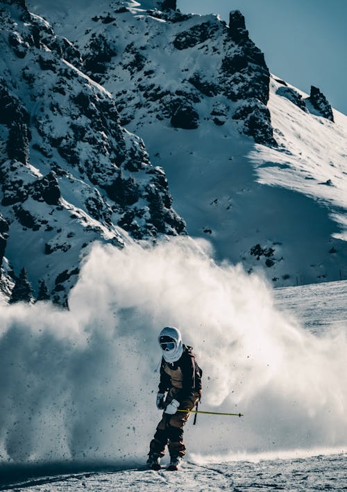 Alpine Skier Raising Snow on a Mountain Slope