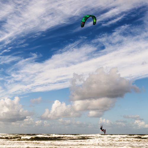 Free A kitesurfer catches air above the ocean in Ringkøbing, Denmark. Perfect for adventure seekers. Stock Photo
