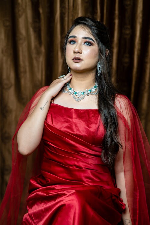 Young Woman Posing in a Long Red Dress 