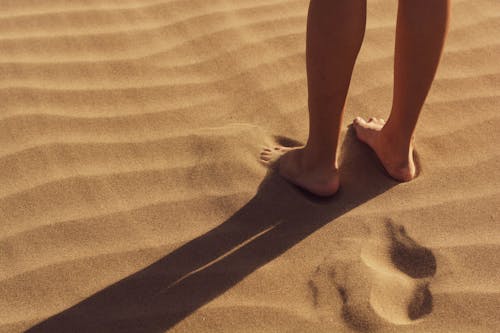 Free Person Stand on Sand Stock Photo