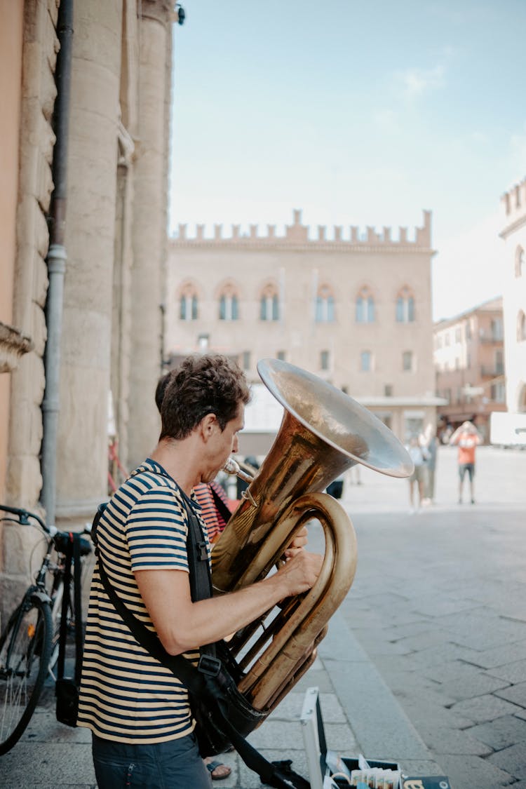 Man Playing A Tuba In The City