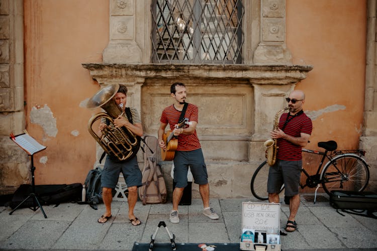 Trio Of Musicians Playing On An Old Town