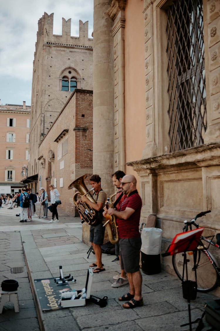 Three Musicians Playing On An Old Town Street