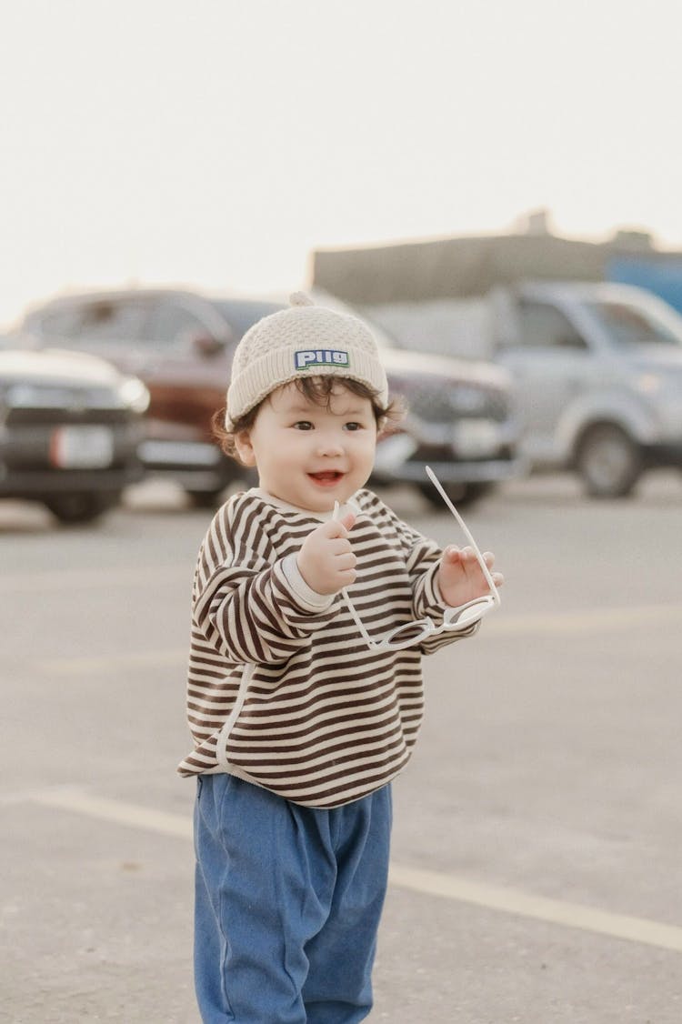 Little Boy Holding Glasses