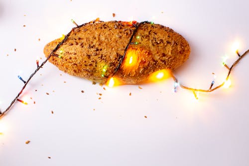 Free Brown Bread With String Light on White Surface Stock Photo