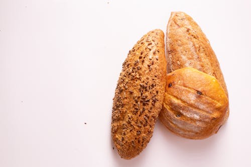 Three Breads on White Surface