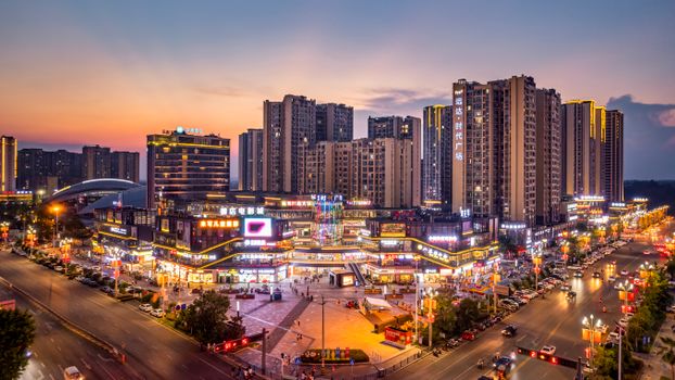Captivating view of Zigong, Sichuan cityscape at sunset showcasing modern architecture and illuminated streets.