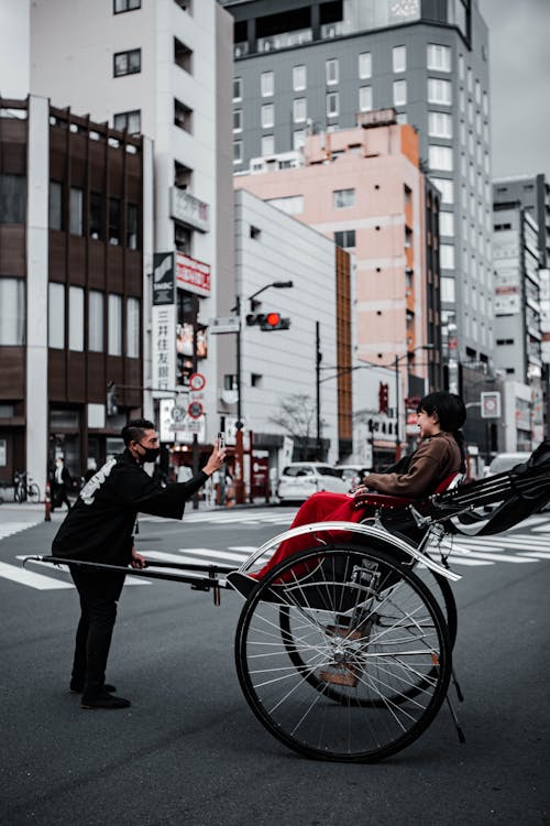 Woman on a Rickshaw in a City 