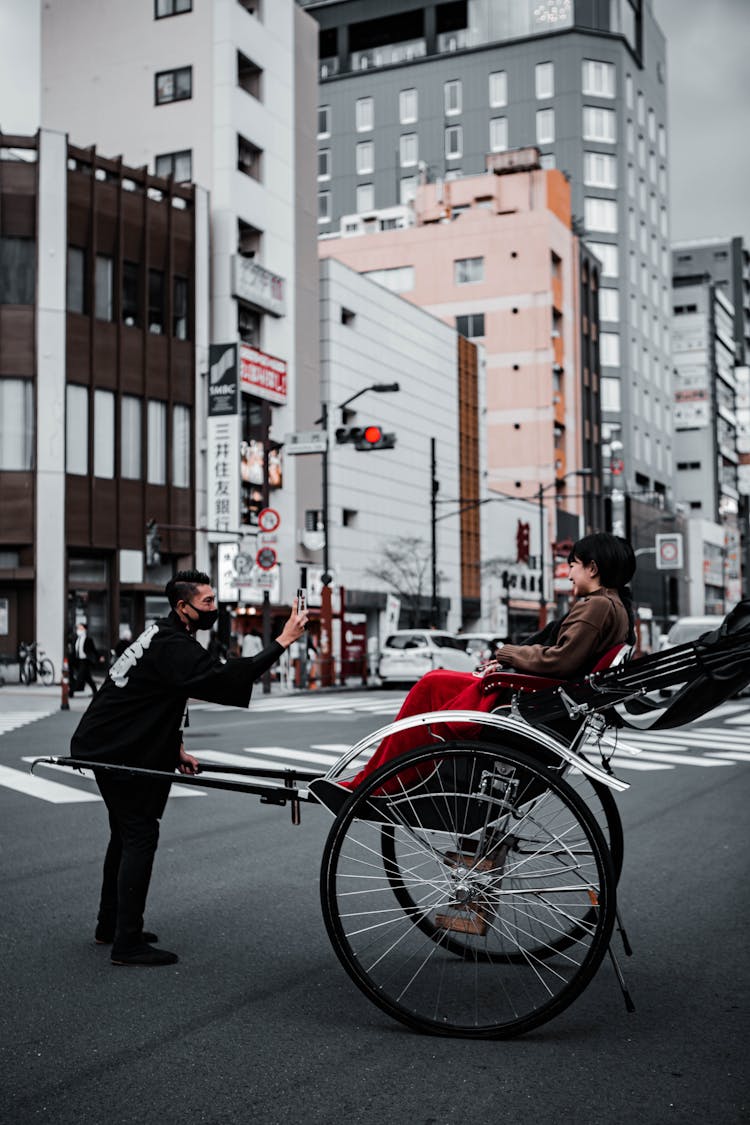 Woman On A Rickshaw In A City 