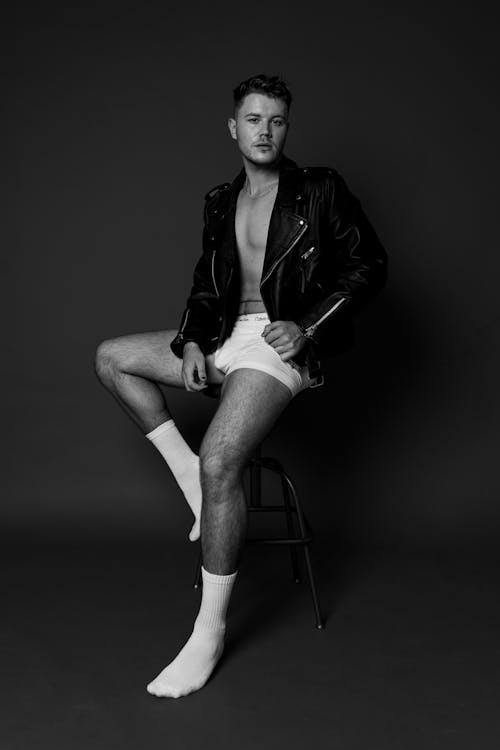 Man in a Leather Jacket Sitting on a Stool 