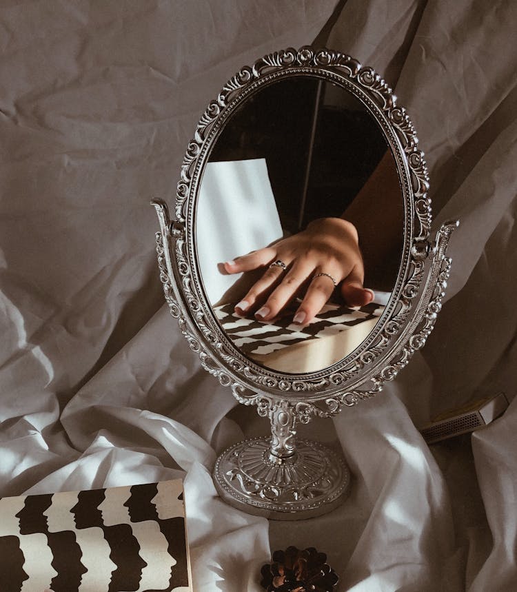 Woman Hand Reflection In Decorative Mirror