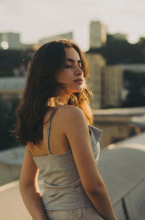 Free A tranquil moment captured during golden hour in Baku, featuring a young woman with eyes closed. Stock Photo