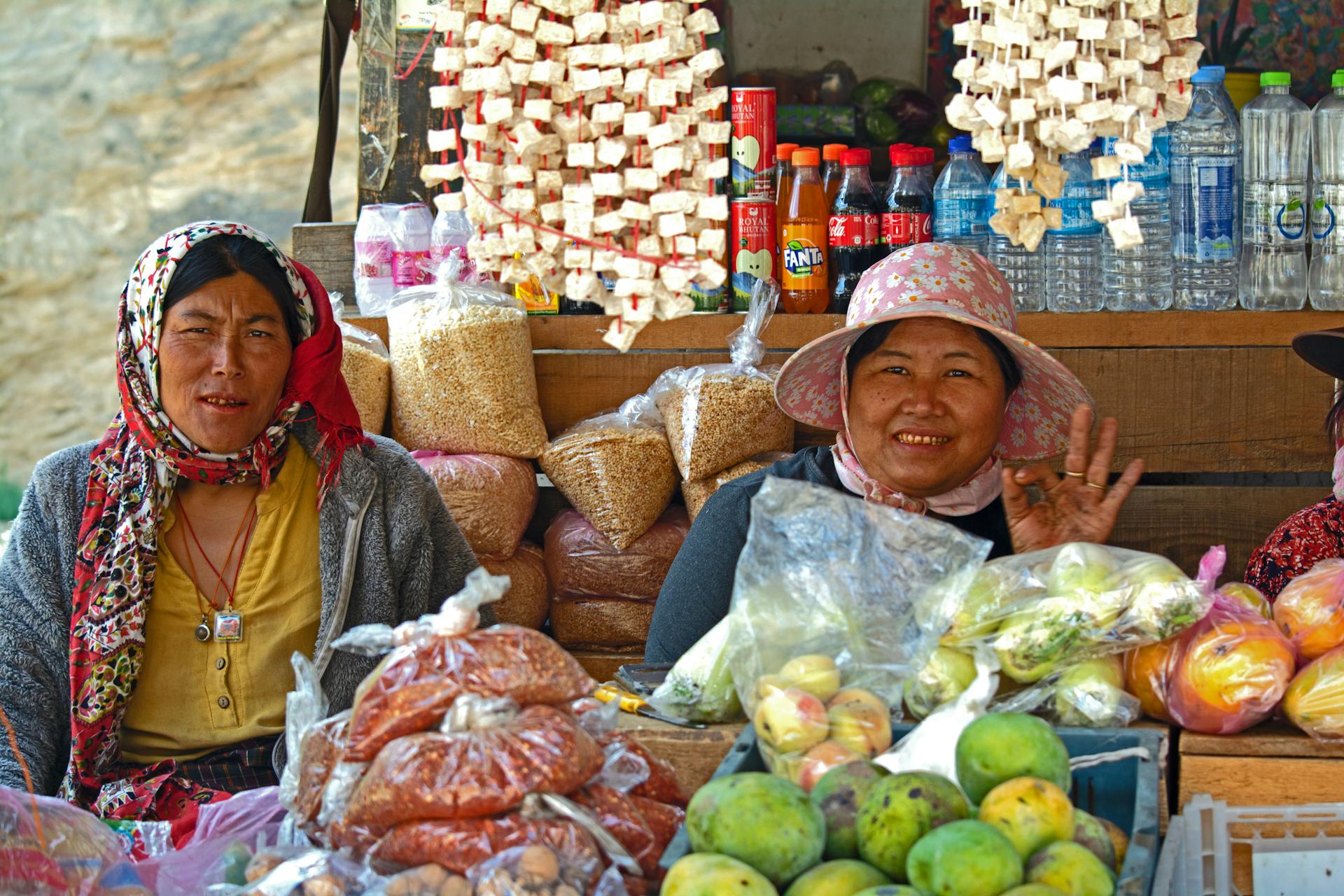 Two women vendors selling fresh produce at a market in Thimphu, Bhutan.