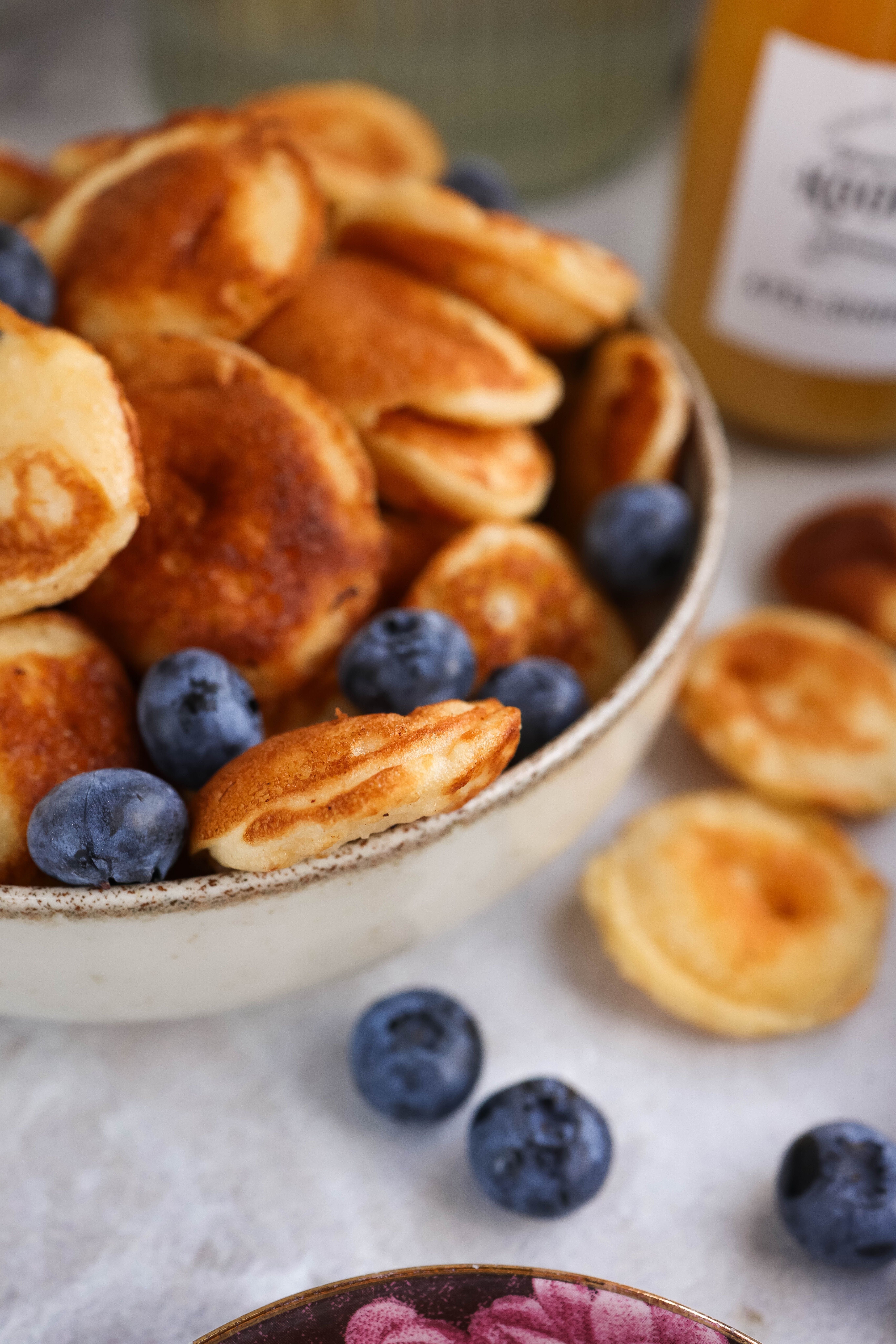 Bowl of mini pancakes with fresh blueberries