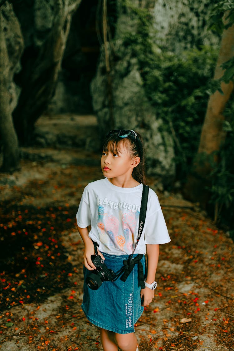 Girl With Camera In Forest