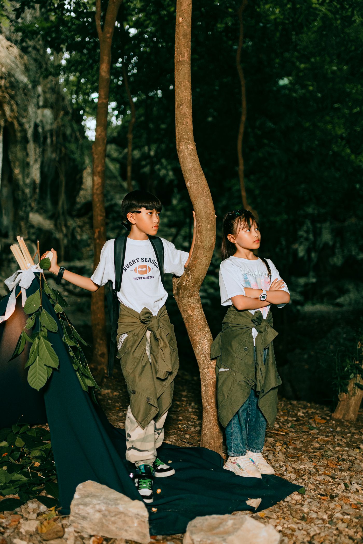Two children on a forest adventure, surrounded by trees