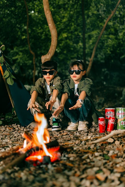 Boy and Girl Camping in the Forest by the Fire 