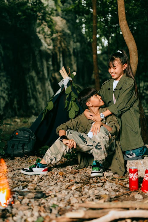 Smiling Teenagers Hugging on Camping