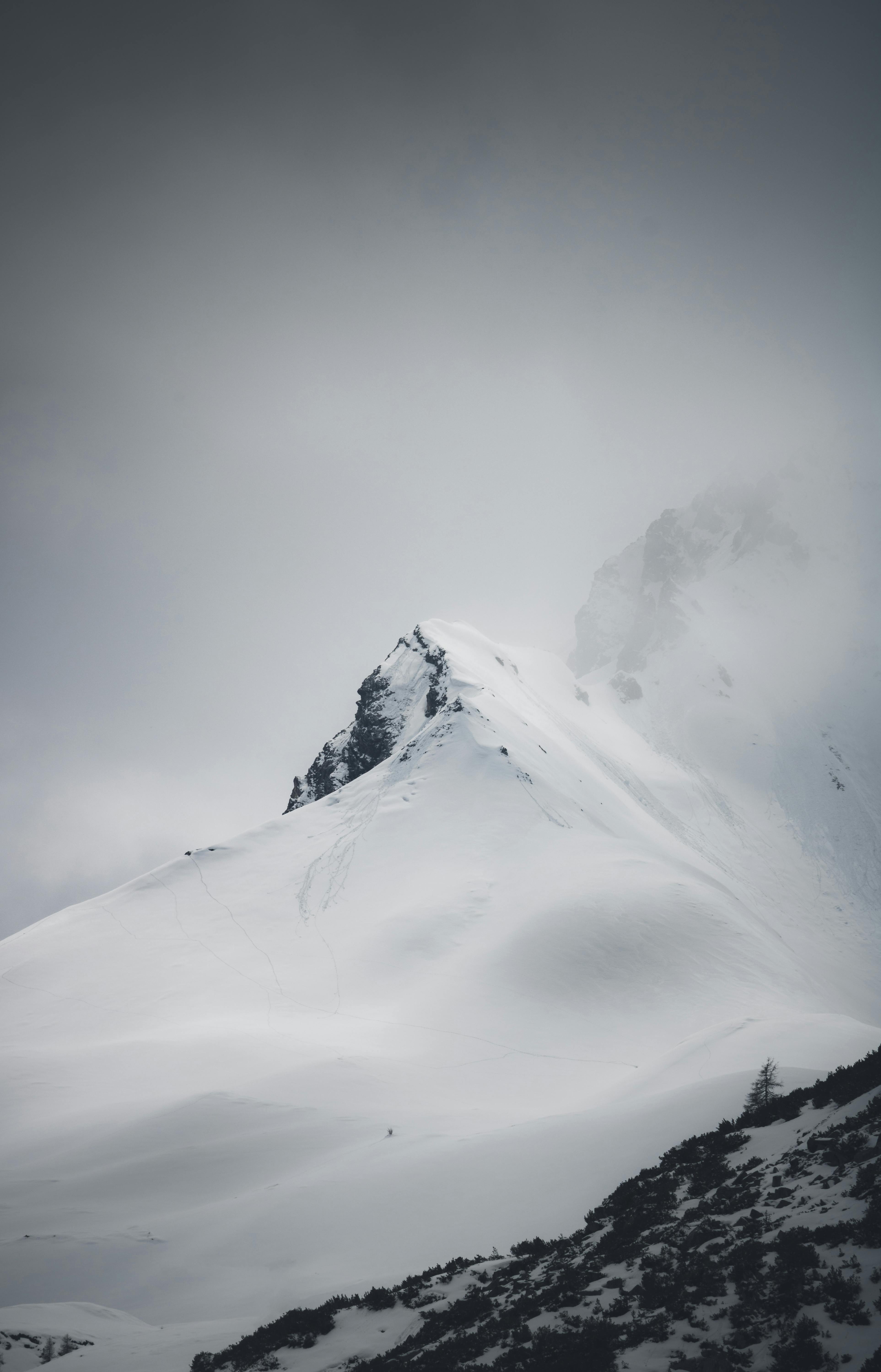 a snowy mountain with a snow covered peak