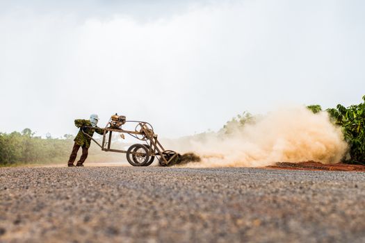 Person Using Cultivator in Crop Field