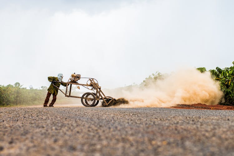 Person Using Cultivator In Crop Field