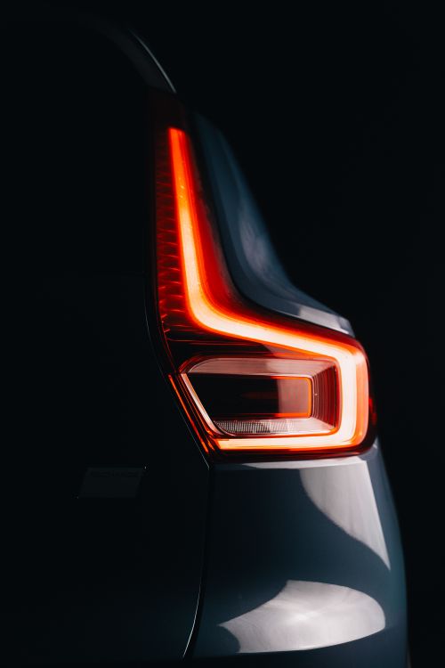 Free Close-up view of a car's modern tail light design captured in a studio setting, emphasizing sleek lines and elegance. Stock Photo