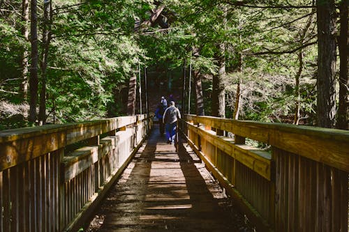 Free Two Persons Walking at Foot Bridge Stock Photo