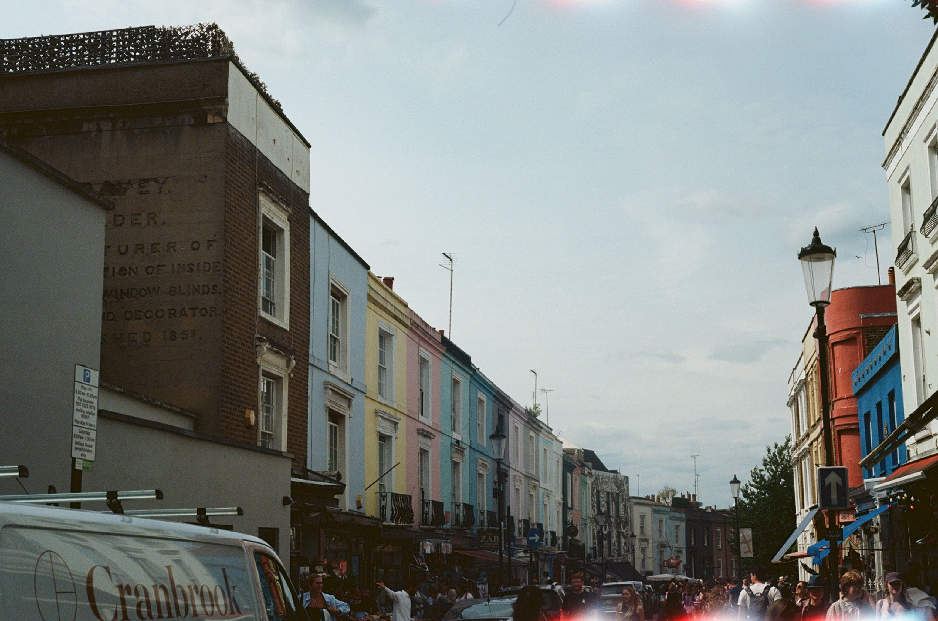 person walking through a vibrant city street with shops and cafes - Centrally located apartments