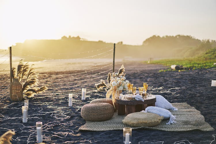 Table And Decorations On Beach At Sunset