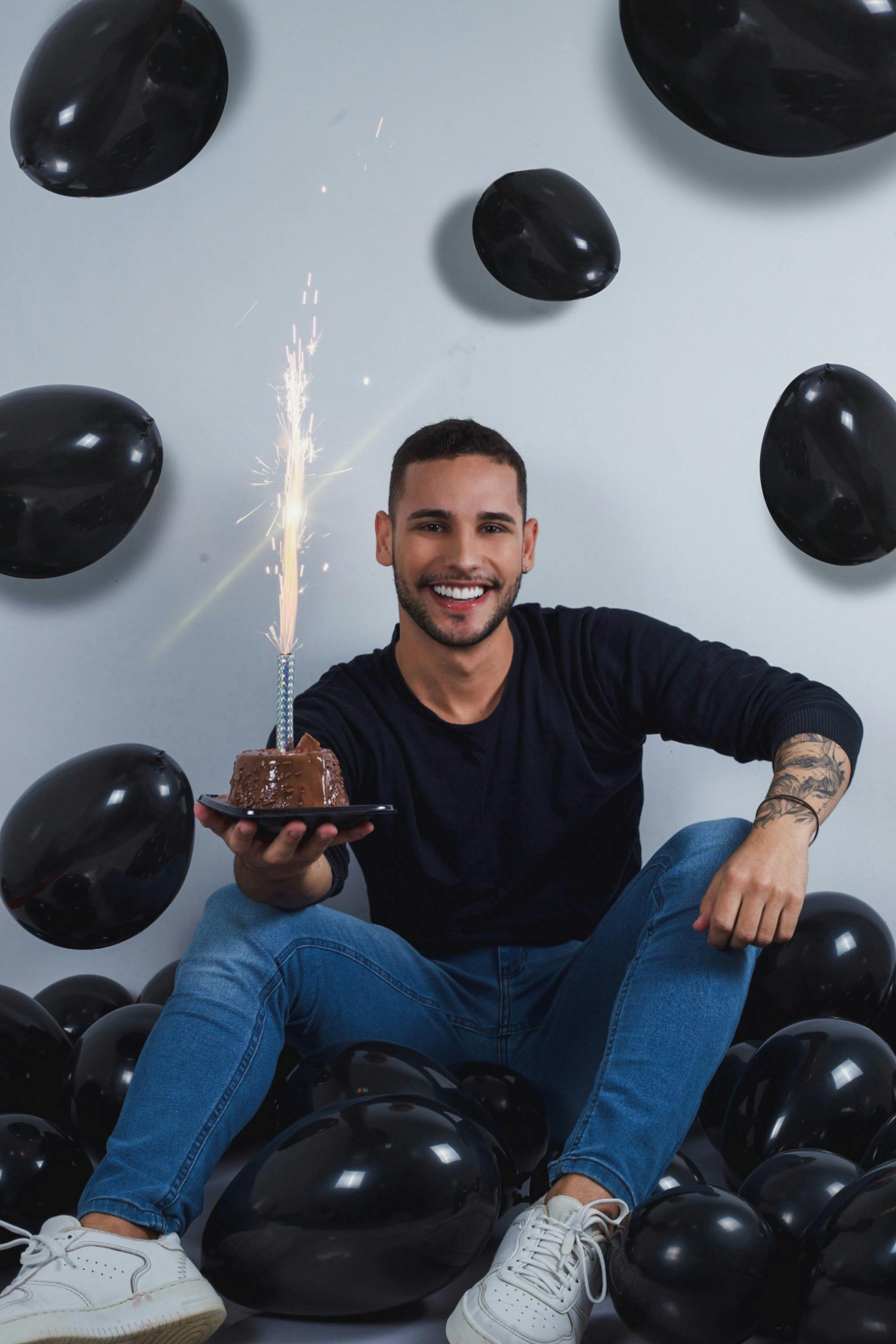 Smiling Man Sitting with Birthday Cake · Free Stock Photo