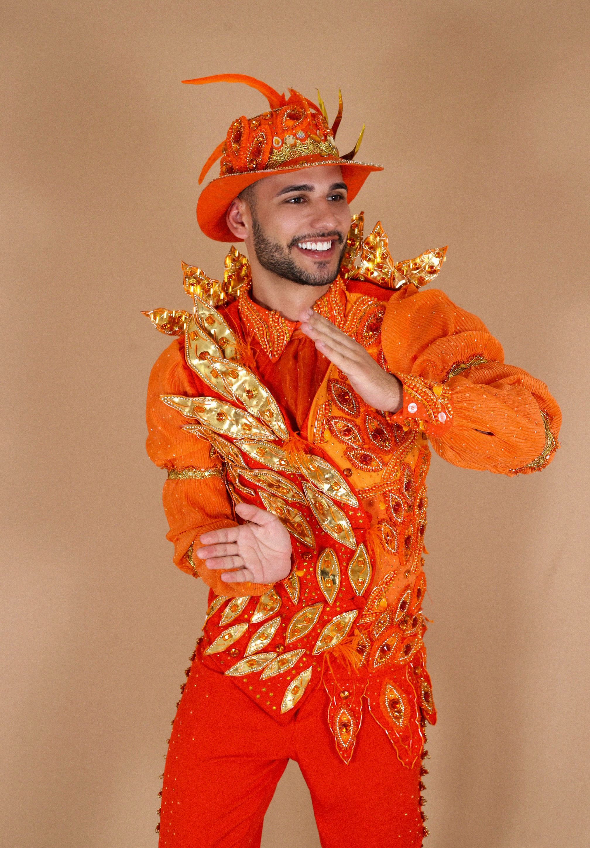 Colorful portrait of a joyful man in an elaborate orange costume, symbolizing celebration.