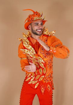 Colorful portrait of a joyful man in an elaborate orange costume, symbolizing celebration.