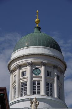 Close-up of Helsinki Cathedral's dome with clear blue sky, showcasing its architectural detail.