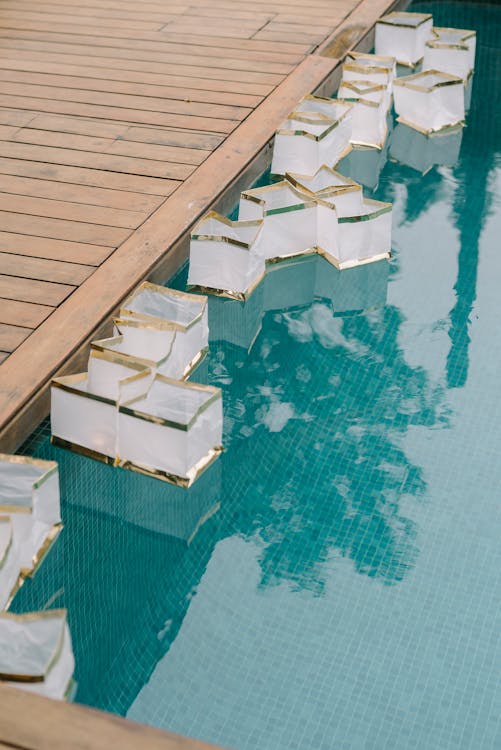 Containers Floating in a Swimming Pool · Free Stock Photo