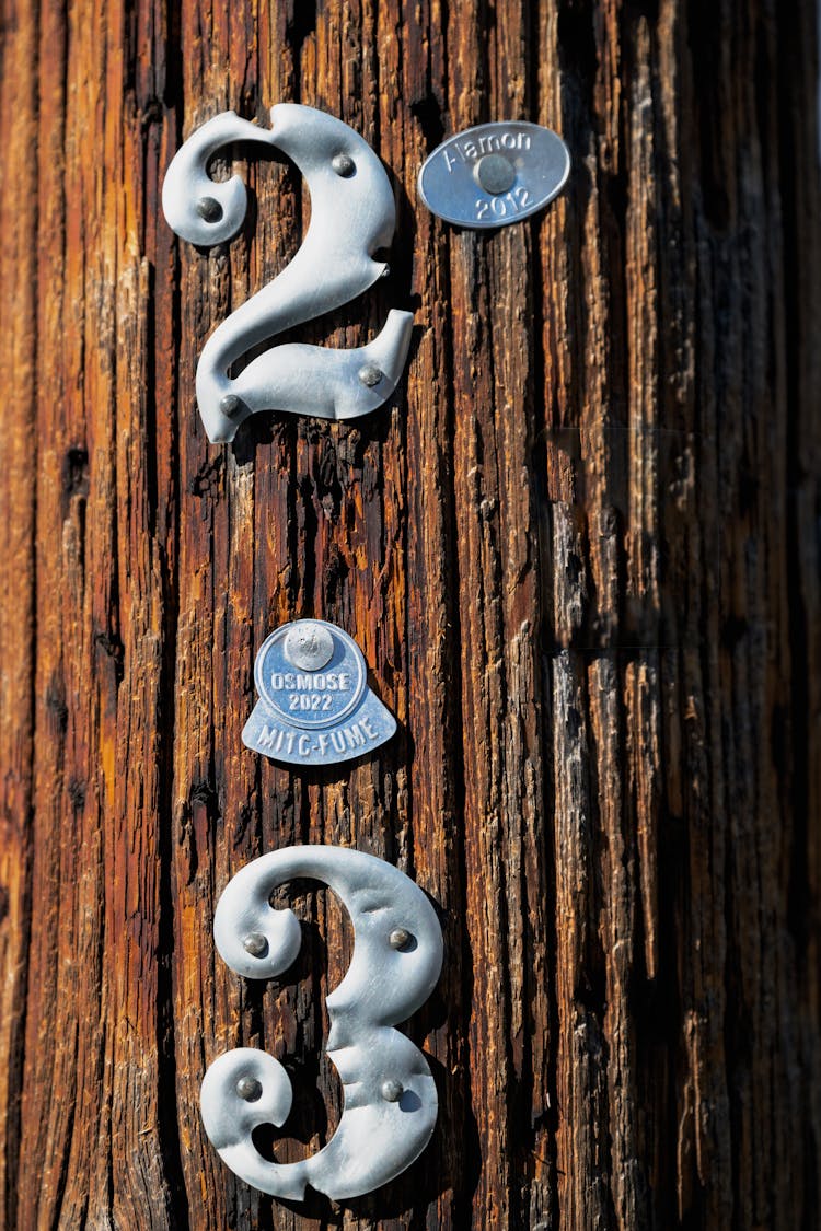 Tin Number Nailed To A Wooden Pole