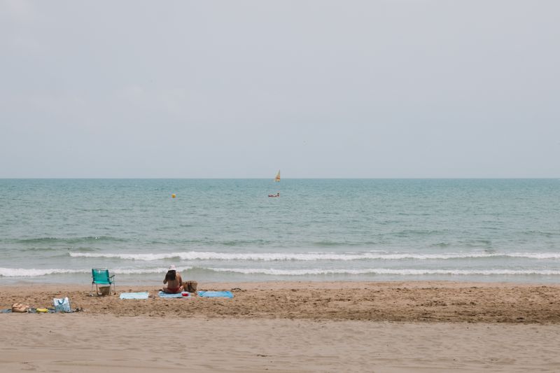 Person enjoying the view of Benidorm beach and calm sea