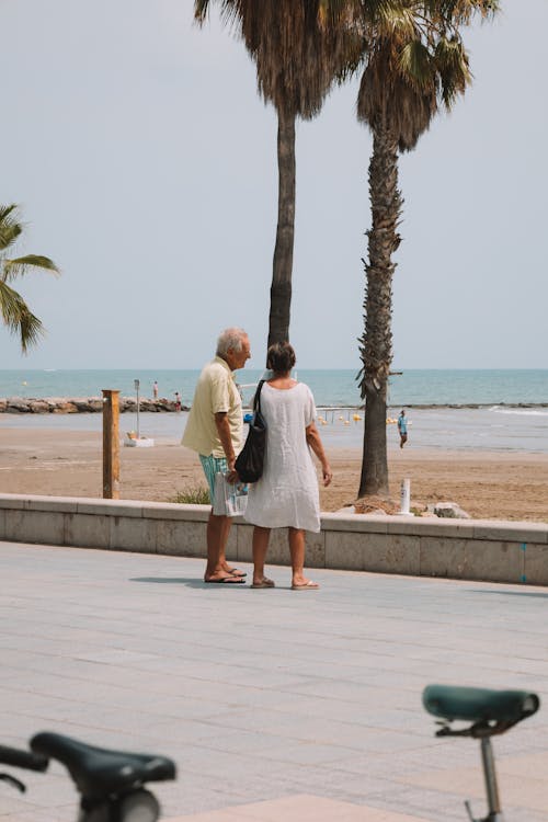 Two People Standing on a Seashore