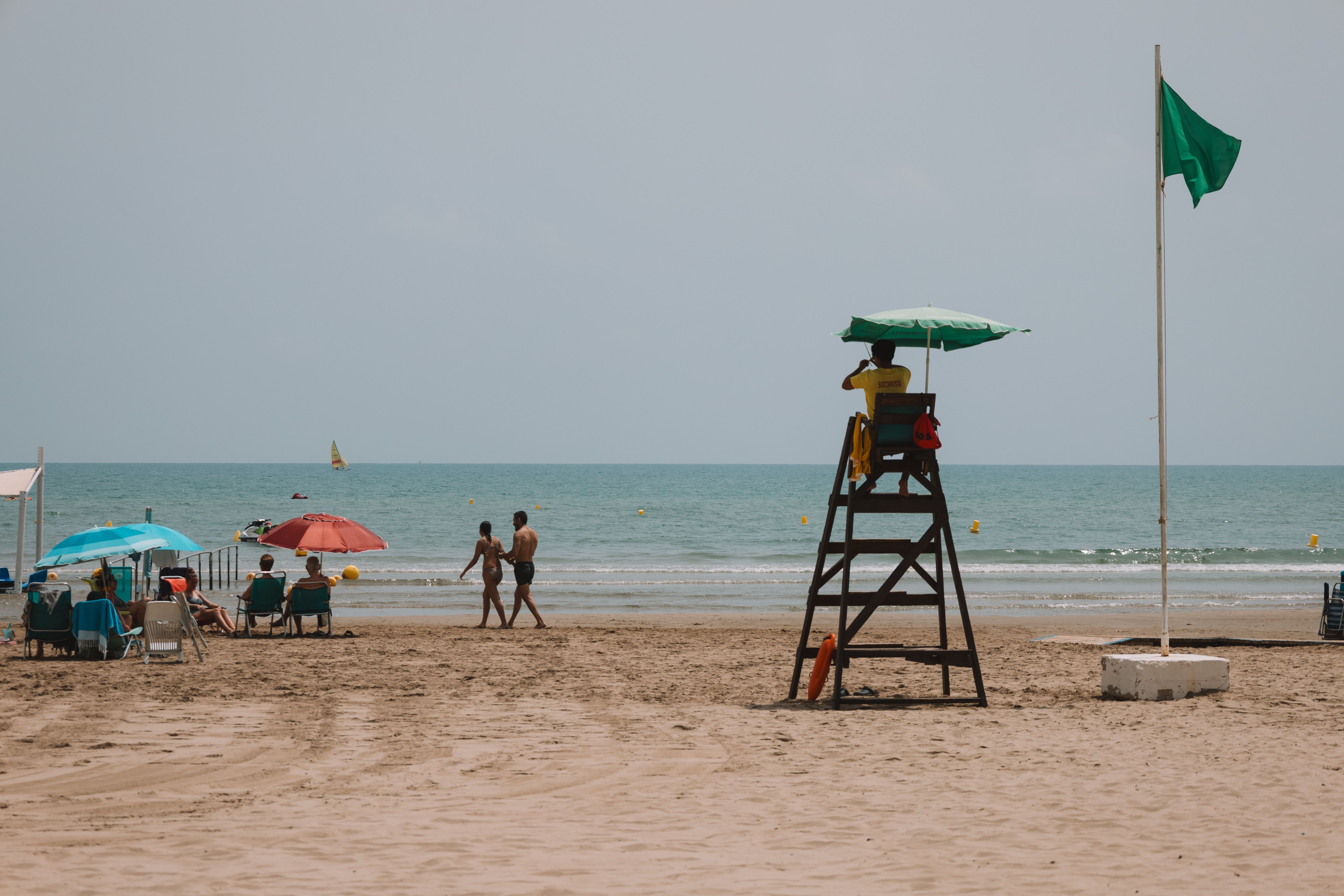 Lifeguard overlooking a sandy beach in Benidorm, Spain on a clear summer day.