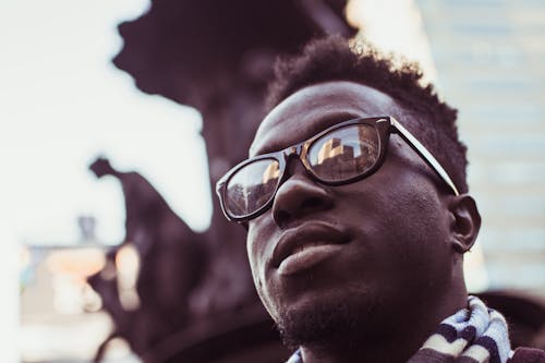 Selective Focus Photo Of Man Wearing Black Framed Sunglasses