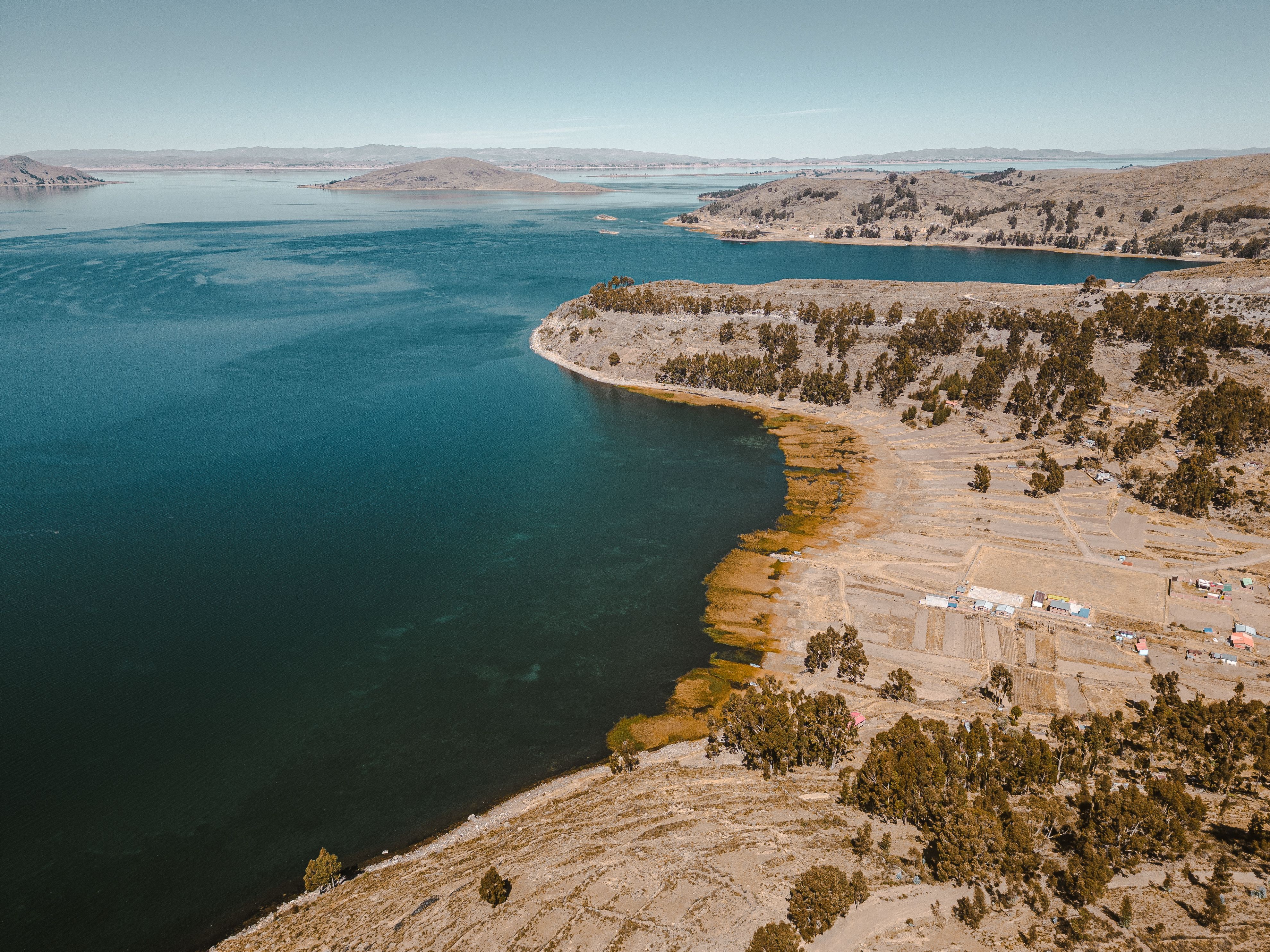 Scenic aerial shot of the coastline and lake in San Pablo De Tiquina, Bolivia, showcasing natural beauty.