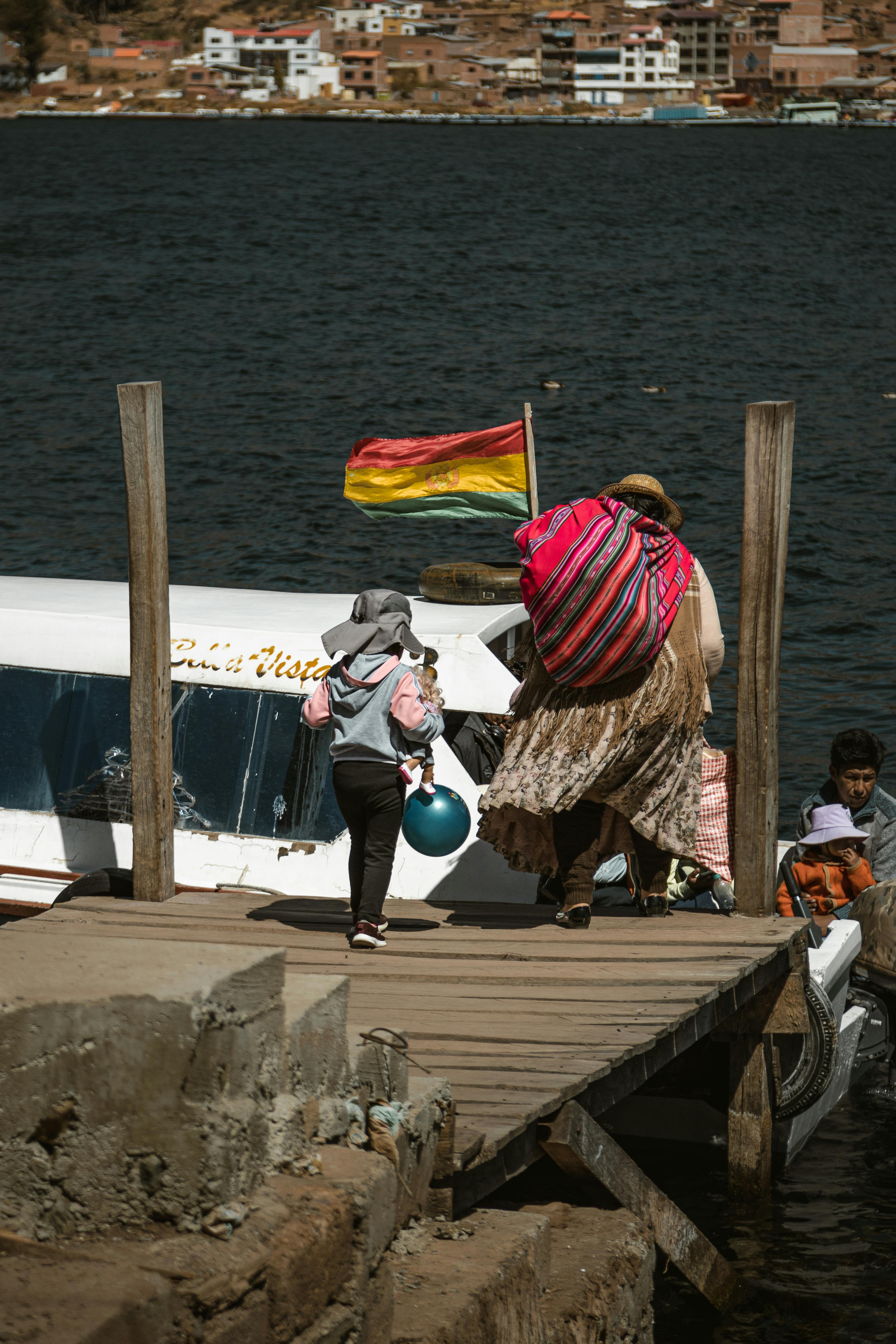 people getting into the boat from a pier