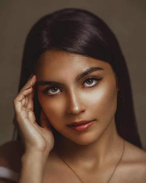 Free Studio portrait of a young brunette woman with striking brown eyes and confident expression. Stock Photo